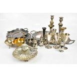 An assortment of silver plated items including twin handled tray, pair of candlesticks, shell shaped