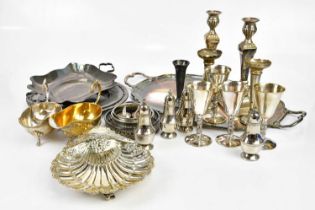 An assortment of silver plated items including twin handled tray, pair of candlesticks, shell shaped