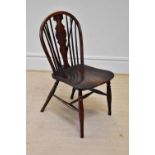 A 19th century elm seated Windsor type chair, height 84cm.