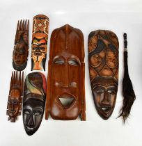 A collection of six decorative African masks, largest 63cm, together with animal hair fly swatter.