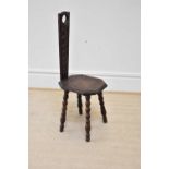 An early 20th century carved oak spinning chair, height 98cm.