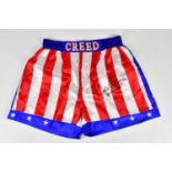 CARL WEATHERS (APOLLO CREED); a pair of 'Stars and Stripes' signed boxing shorts, size XL. Condition
