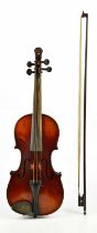 A German full sized violin, with 35.5cm two piece back and carved lion head scroll, with bow and