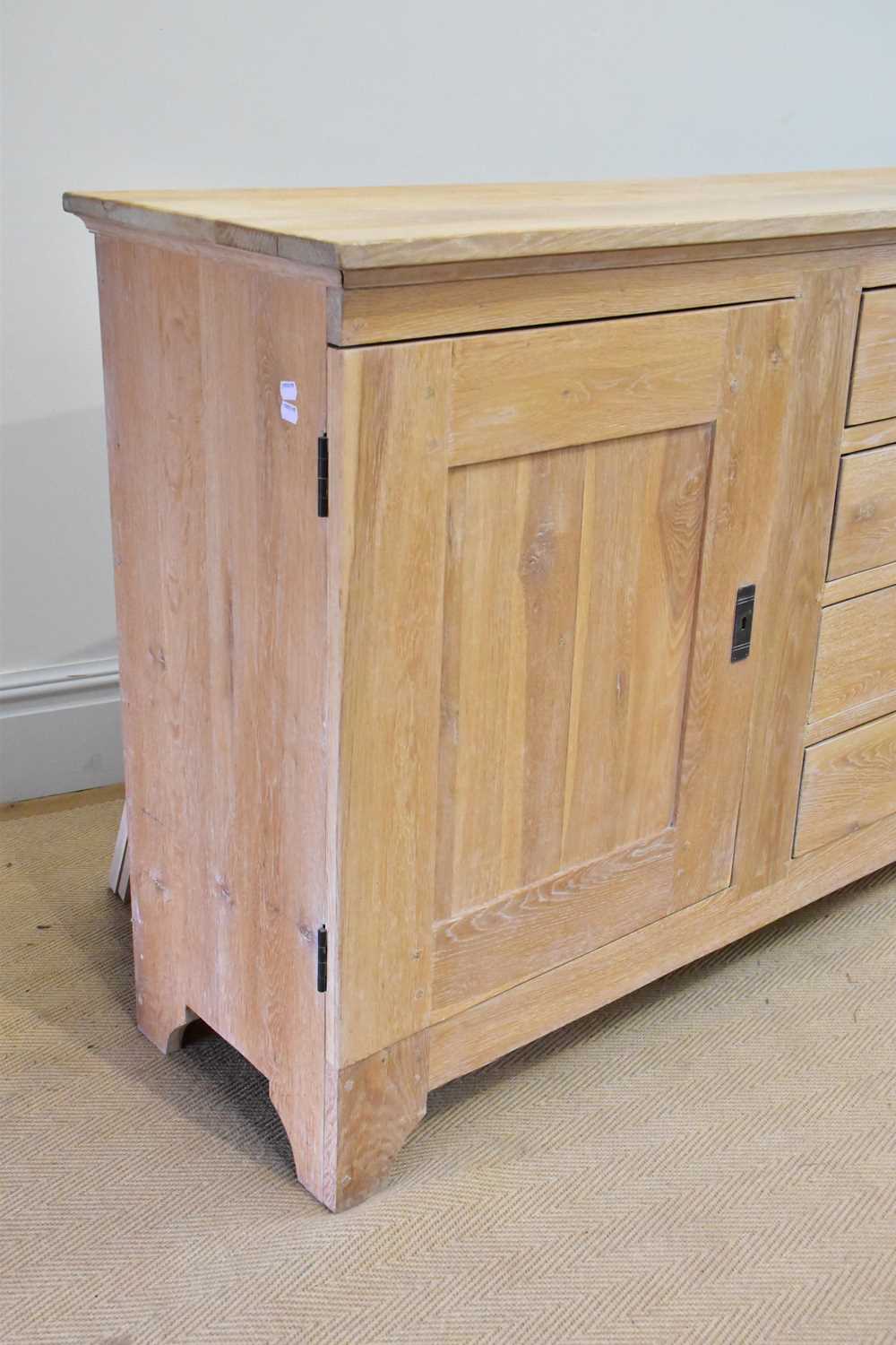 A modern limed oak sideboard with four drawers flanked by panelled cupboard doors, length 216cm, - Image 2 of 5
