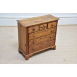 A pine specimen chest of drawers, with an arrangement of seven drawers, on bracket feet, width 54cm,