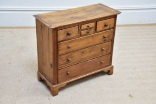 A pine specimen chest of drawers, with an arrangement of seven drawers, on bracket feet, width 54cm,