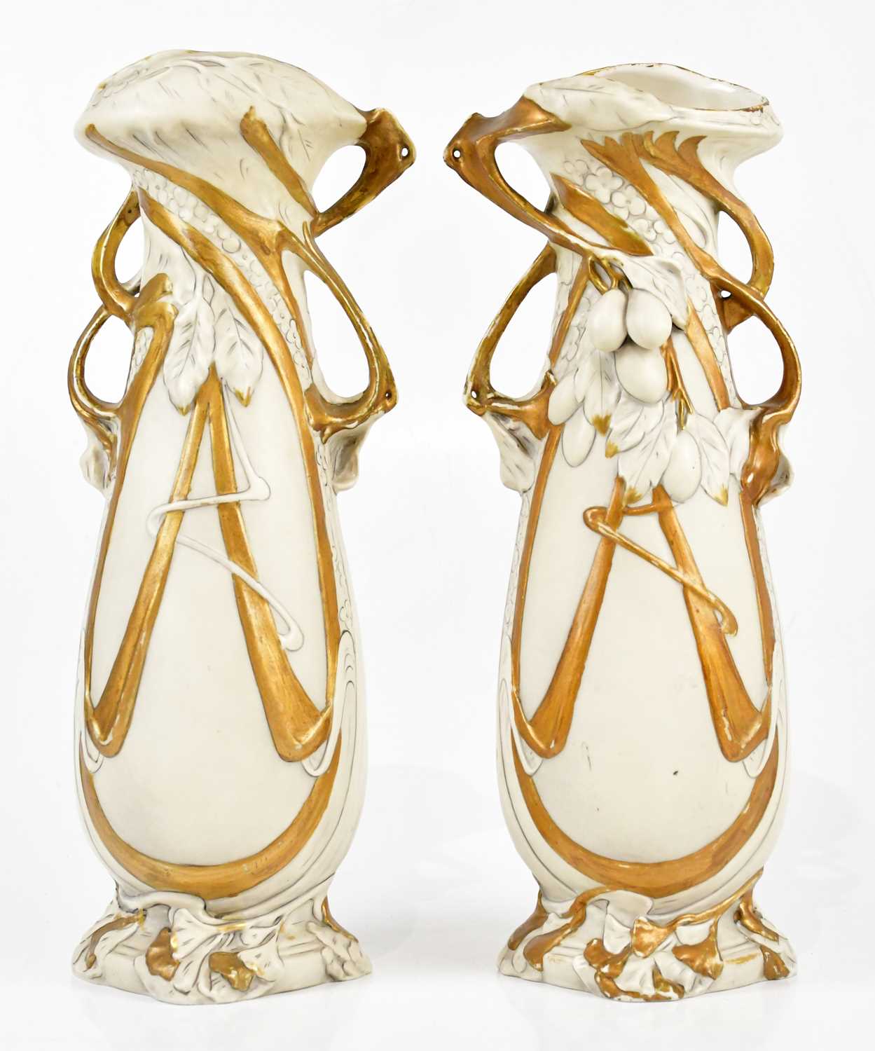 ROYAL DUX; a pair of Art Nouveau twin handled vases, relief decorated with fruit, height 39cm (2).