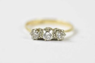 An 18ct yellow gold and graduated three stone diamond ring, the largest stone weighing approx. 0.