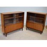 MULTI-WIDTH; a pair of mid century teak bookcases with glass sliding and panelled doors, width