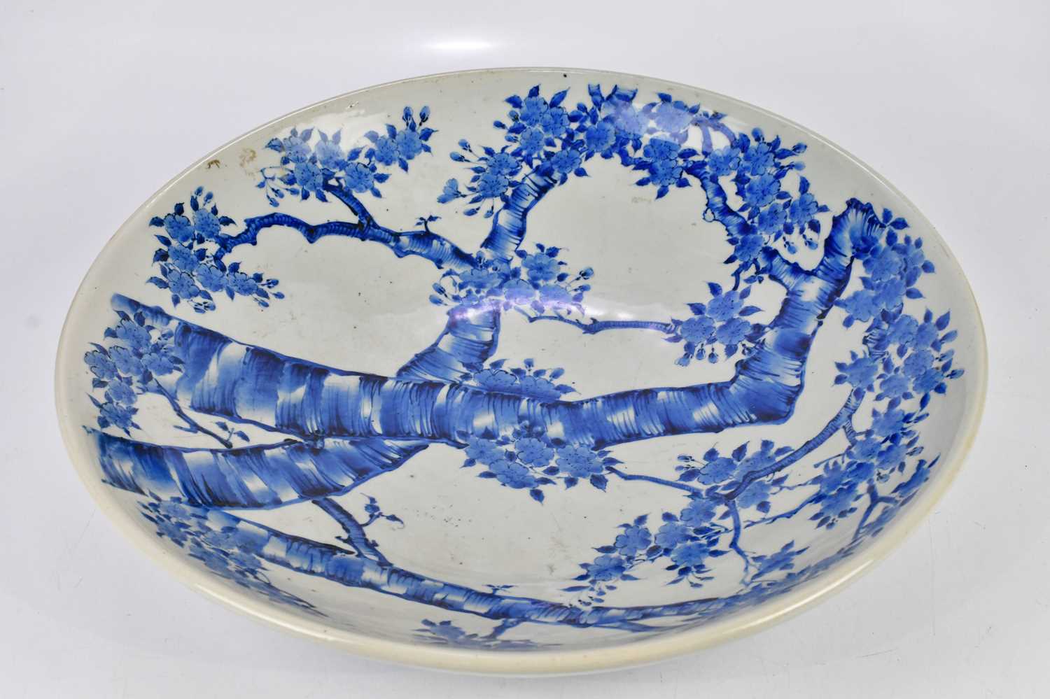 A large modern Japanese blue and white charger, with six character to the underside, diameter 55cm.