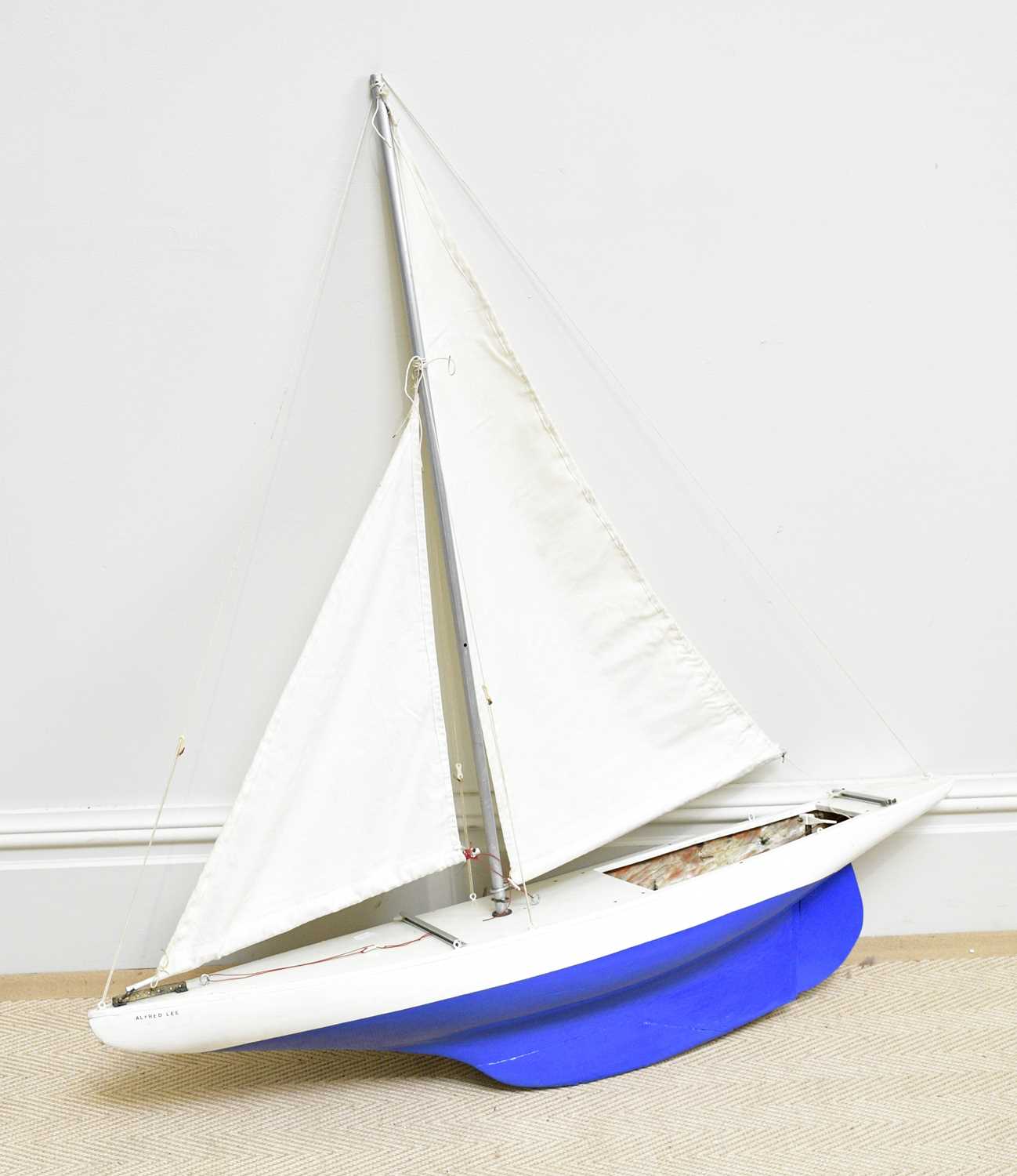 A vintage painted wooden pond yacht with mast, length 103cm.