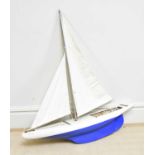 A vintage painted wooden pond yacht with mast, length 103cm.