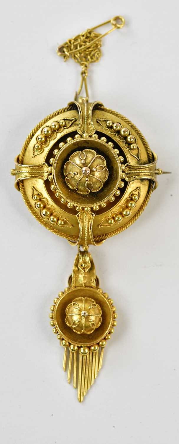 A Victorian yellow metal target brooch/pendant with cast decoration, height 5cm, approx 11.8g,