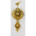 A Victorian yellow metal target brooch/pendant with cast decoration, height 5cm, approx 11.8g,