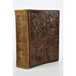 A Black Forest carved bound scrap album, decorated with leaves and berries. Condition Report: The