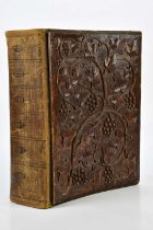 A Black Forest carved bound scrap album, decorated with leaves and berries. Condition Report: The