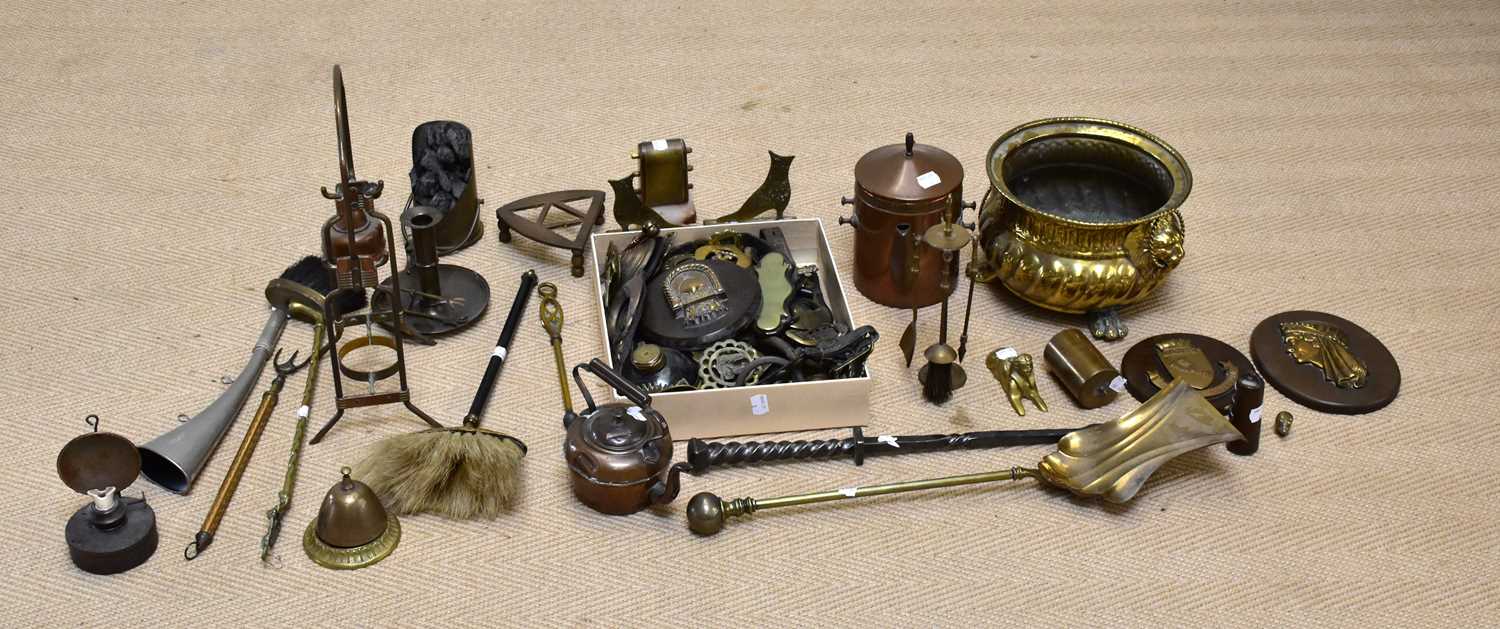 A collection of 19th century and later metalware including a companion set, a fender, horse brasses,