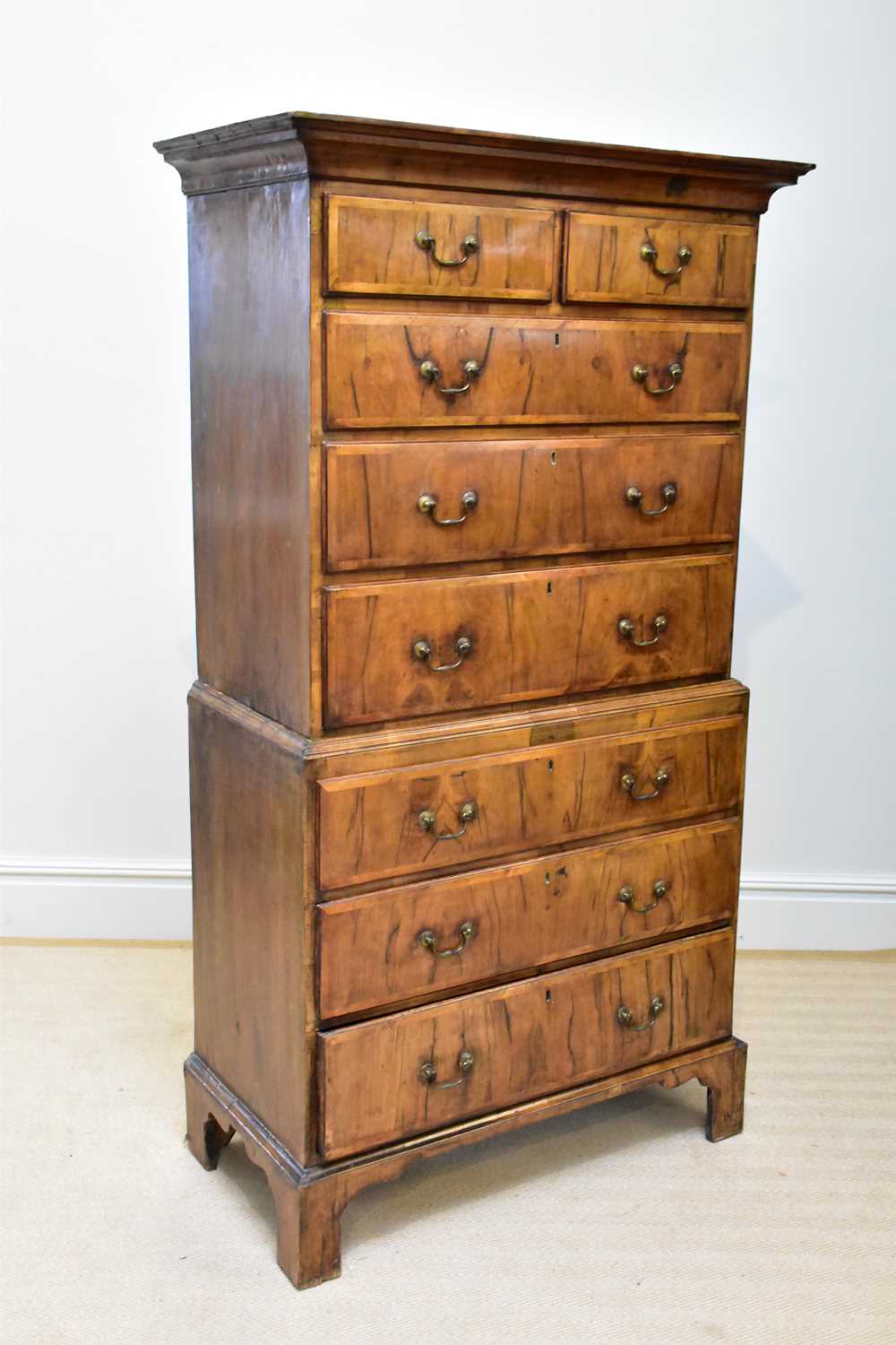A George III walnut chest on chest, with two short and three long drawers, above three further