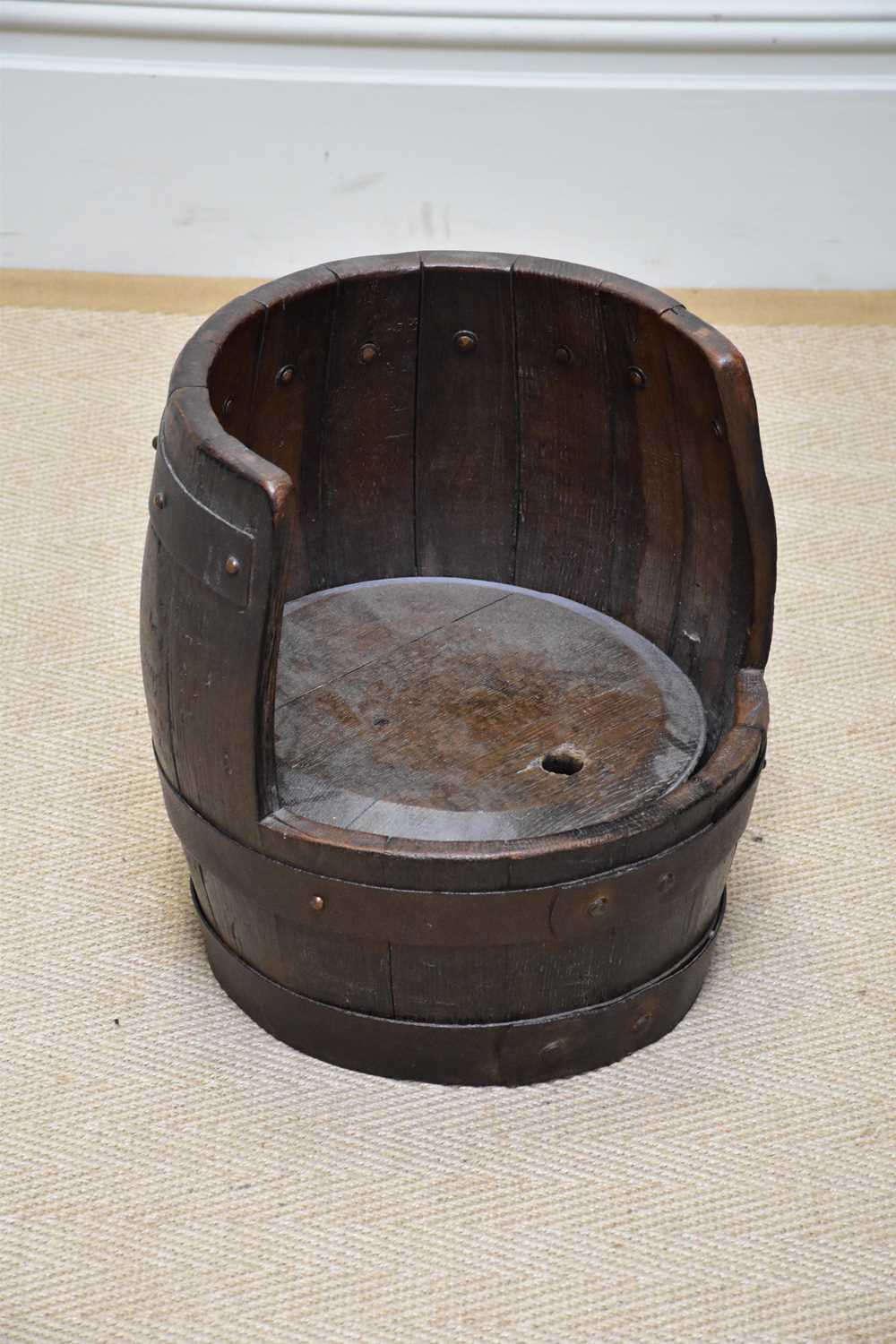 An unusual barrel chair formed as a metal bound bucket, height 35.5cm.