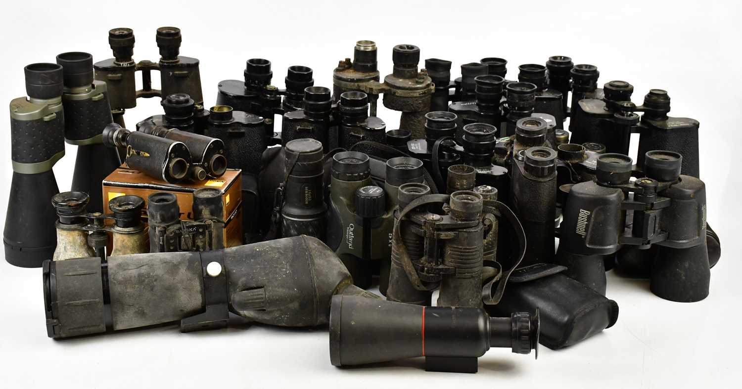 A collection of vintage and modern binoculars and other optical devices, predominantly unboxed.