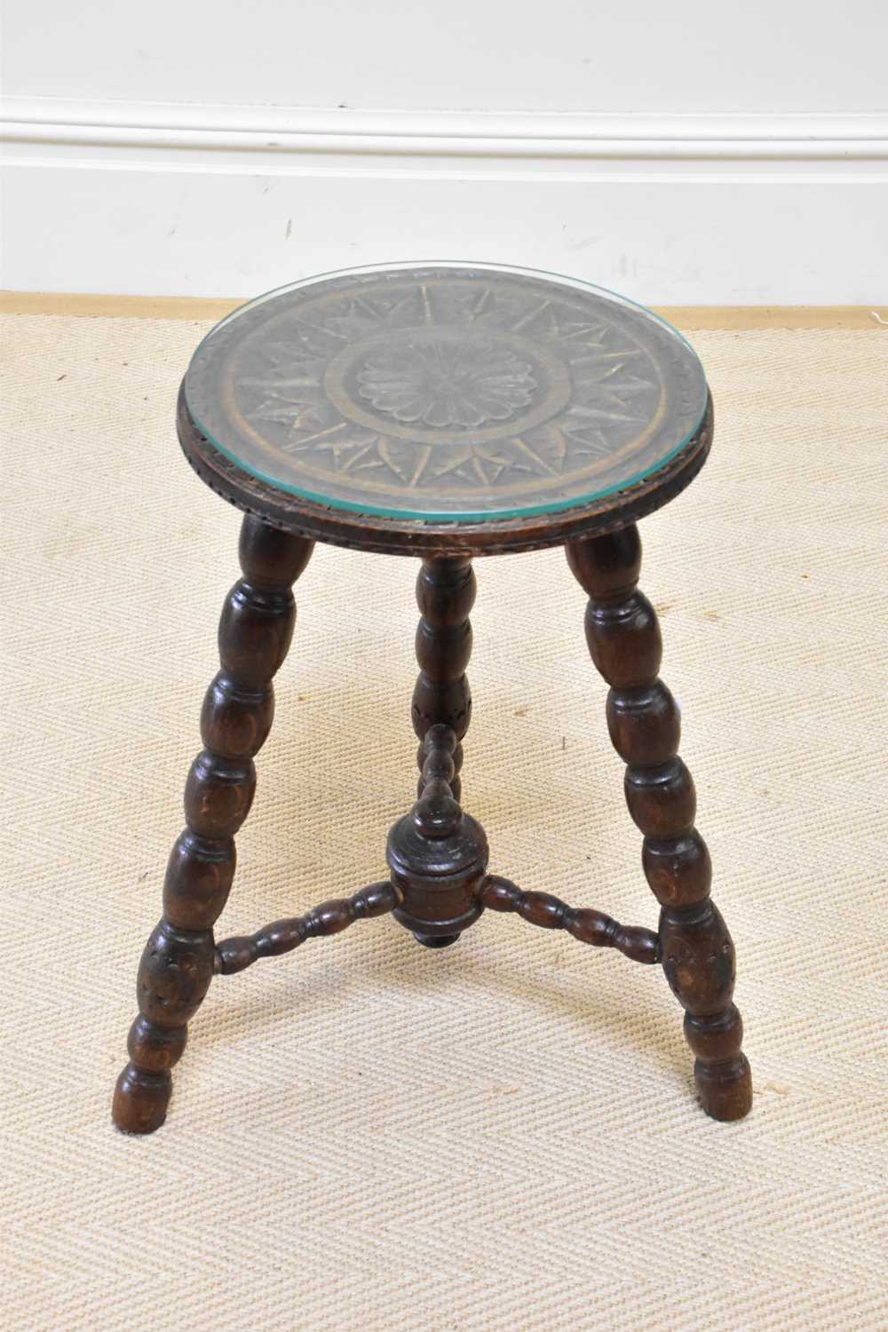A 19th century carved oak stool, height 50cm, diameter 31cm.