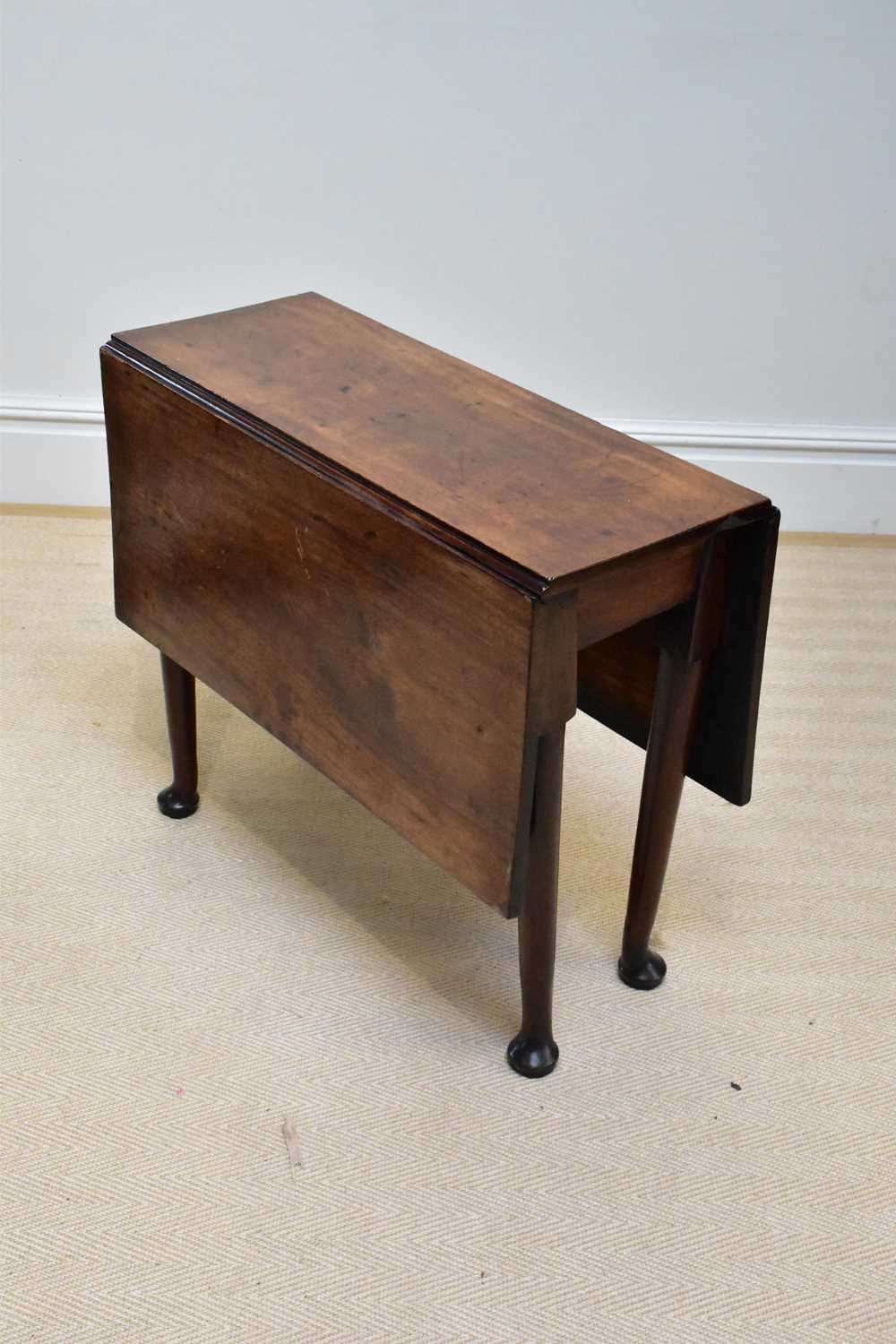 A 19th century mahogany drop-leaf table, on tapered legs and pad feet, height 72cm, width 83cm.