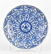 An 18th century Chinese blue and white Kraak ware charger decorated in panels with floral