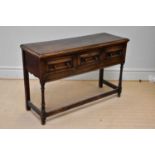 An 18th century style oak dresser base with three drawers, on bun feet, width 133cm, depth 47cm,