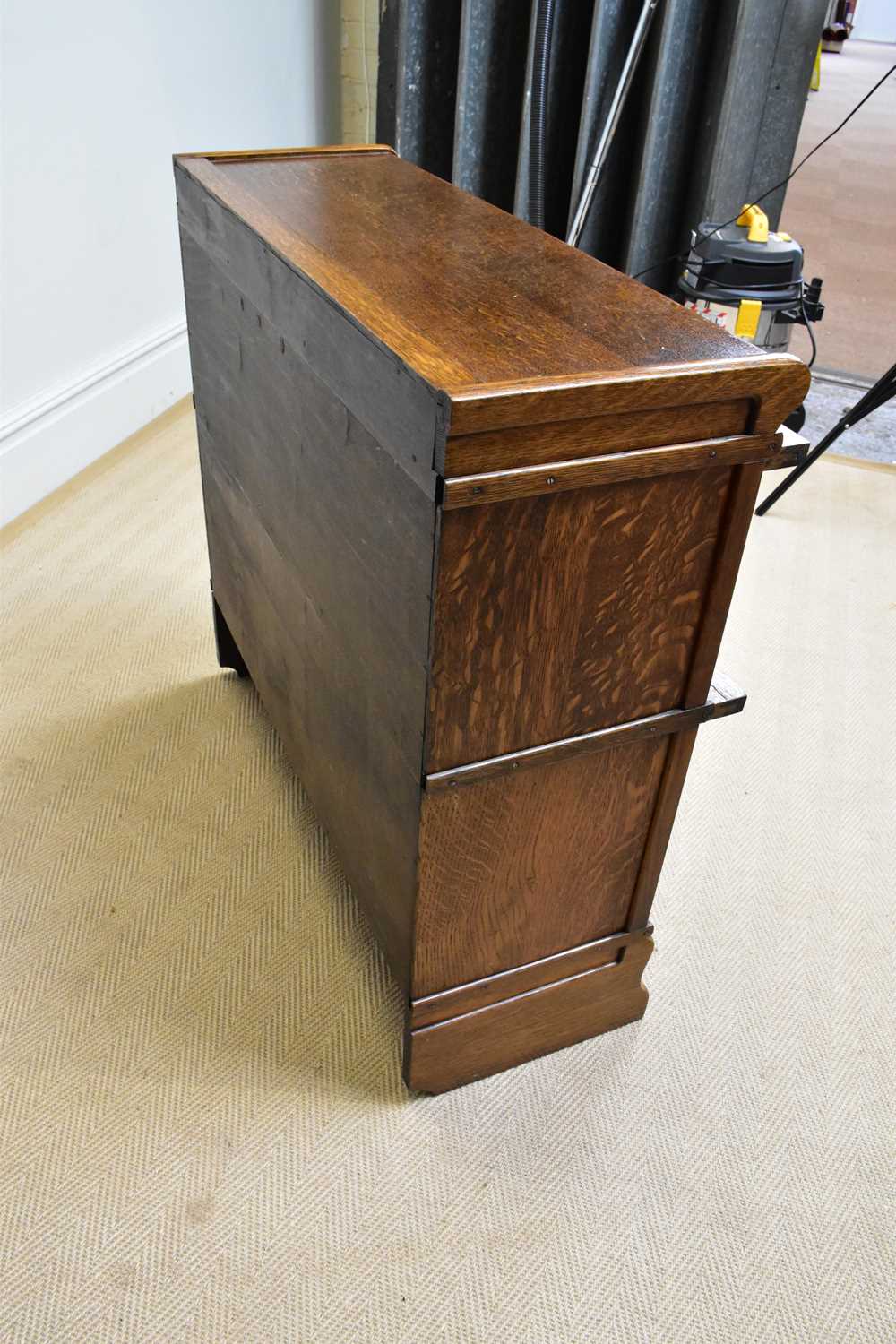 GLOBE WERNICKE; an oak two tier metal bound stacking bookcase with leaded glazed up and over door, - Image 4 of 4