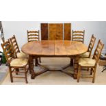 A good quality reproduction burr oak extendable dining table with three additional leaves on block