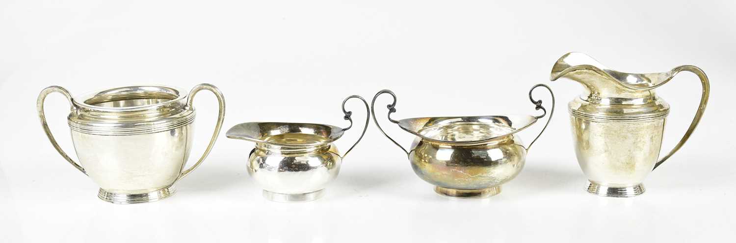 A George V hallmarked silver jug and sugar bowl, Birmingham 1919, and another jug and sugar,
