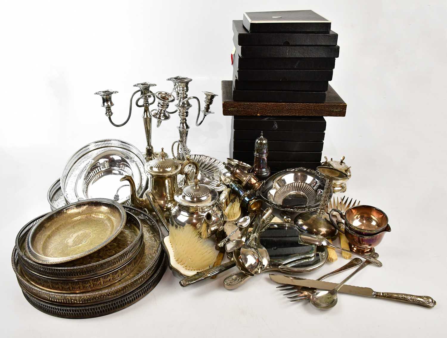 A large collection of silver plated items to include candlesticks, cutlery, trays, a teapot, a