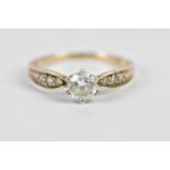 A yellow metal dress ring stamped 375 set with a central glass stone and similar glass stones to the