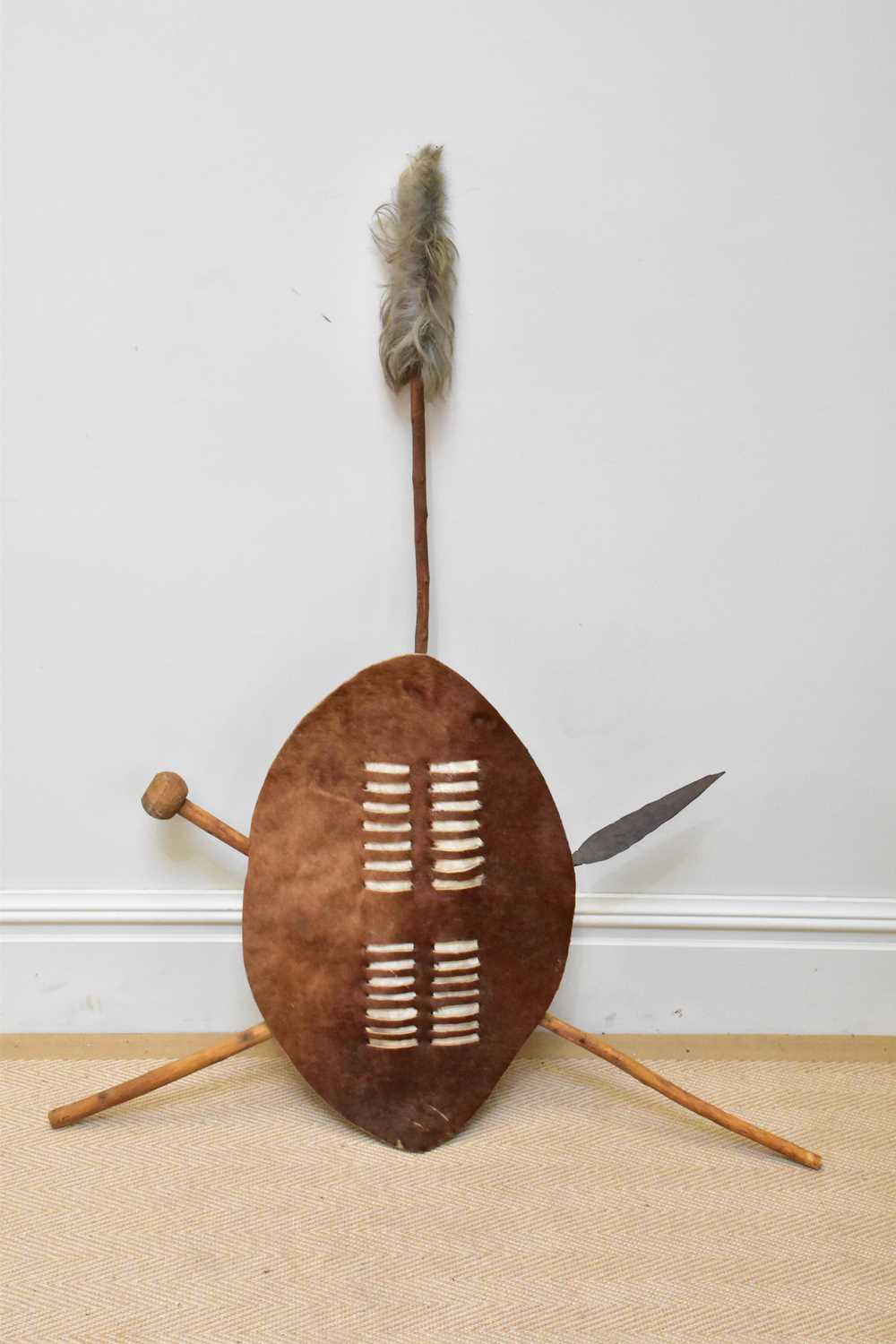 A 20th century Zulu shield, spear and knobkerrie.