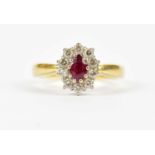 An 18ct gold diamond and ruby oval ring, stamped '750', gross weight 6.0g.