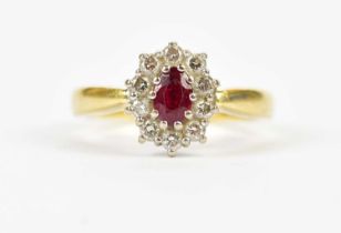 An 18ct gold diamond and ruby oval ring, stamped '750', gross weight 6.0g.