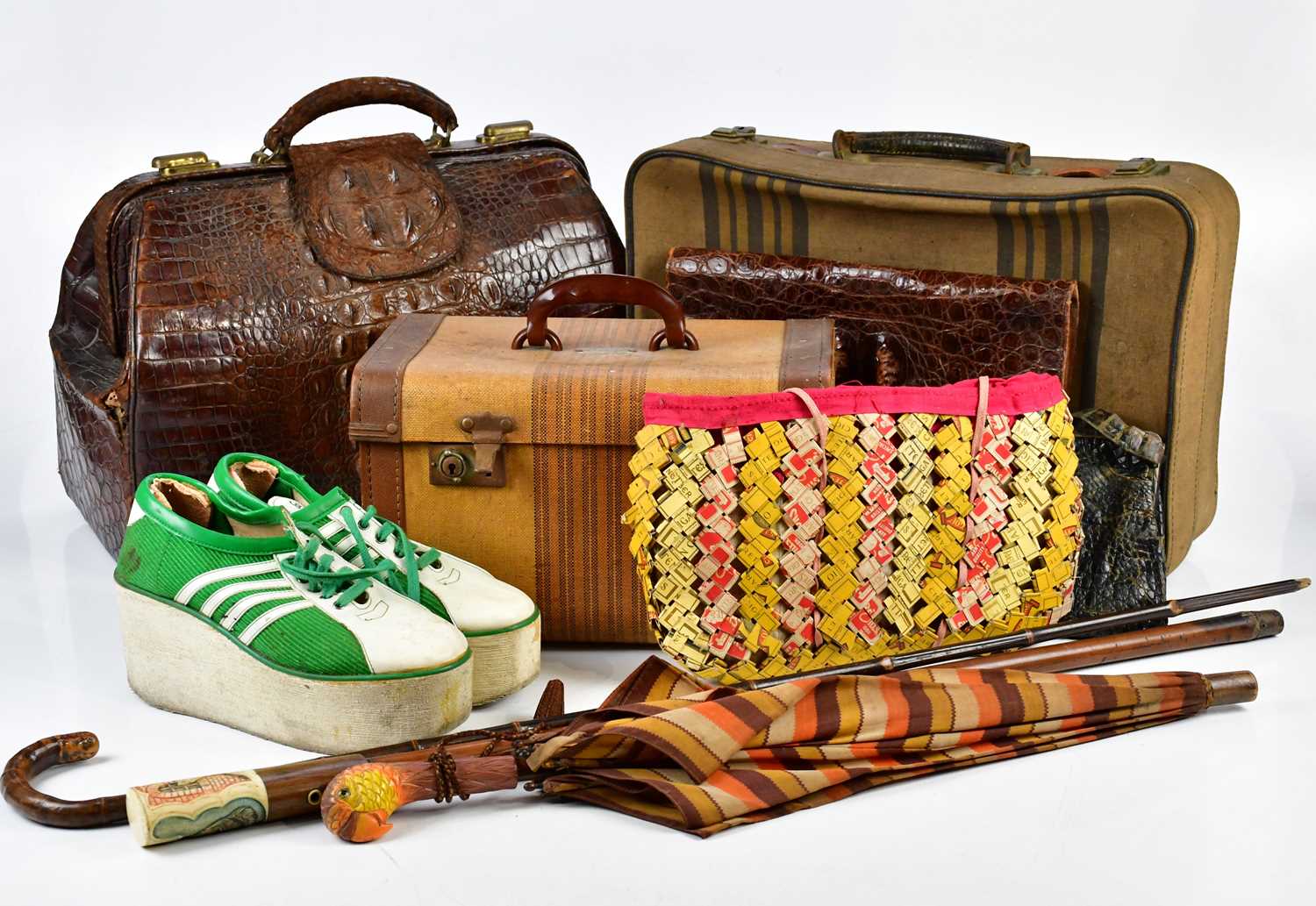 A crocodile skin Gladstone type bag, with a vanity type case, a small suitcase, two further animal