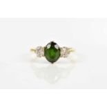 An 18ct gold and platinum diamond and tourmaline three stone ring, size K, approx 2.7g. Condition