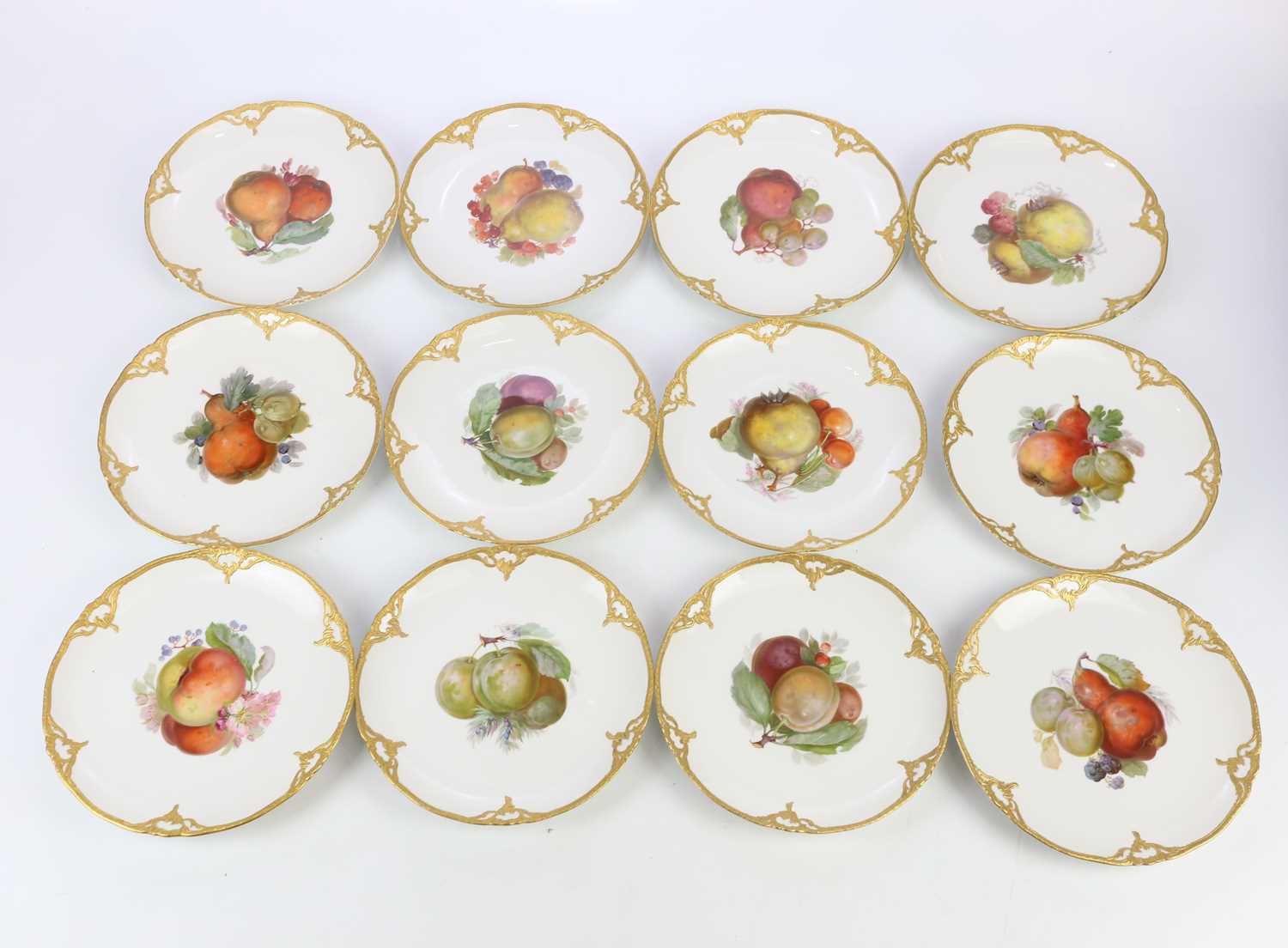 KPM; a collection of twelve hand painted porcelain plates, each decorated with fruit to the