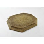 MOUSEMAN; an oak bread board of canted rectangular form, 30.5 x 25cm.
