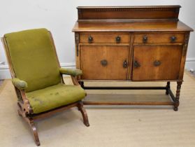 An early 20th century oak sideboard, with two drawers above two panelled cupboard doors, on bun
