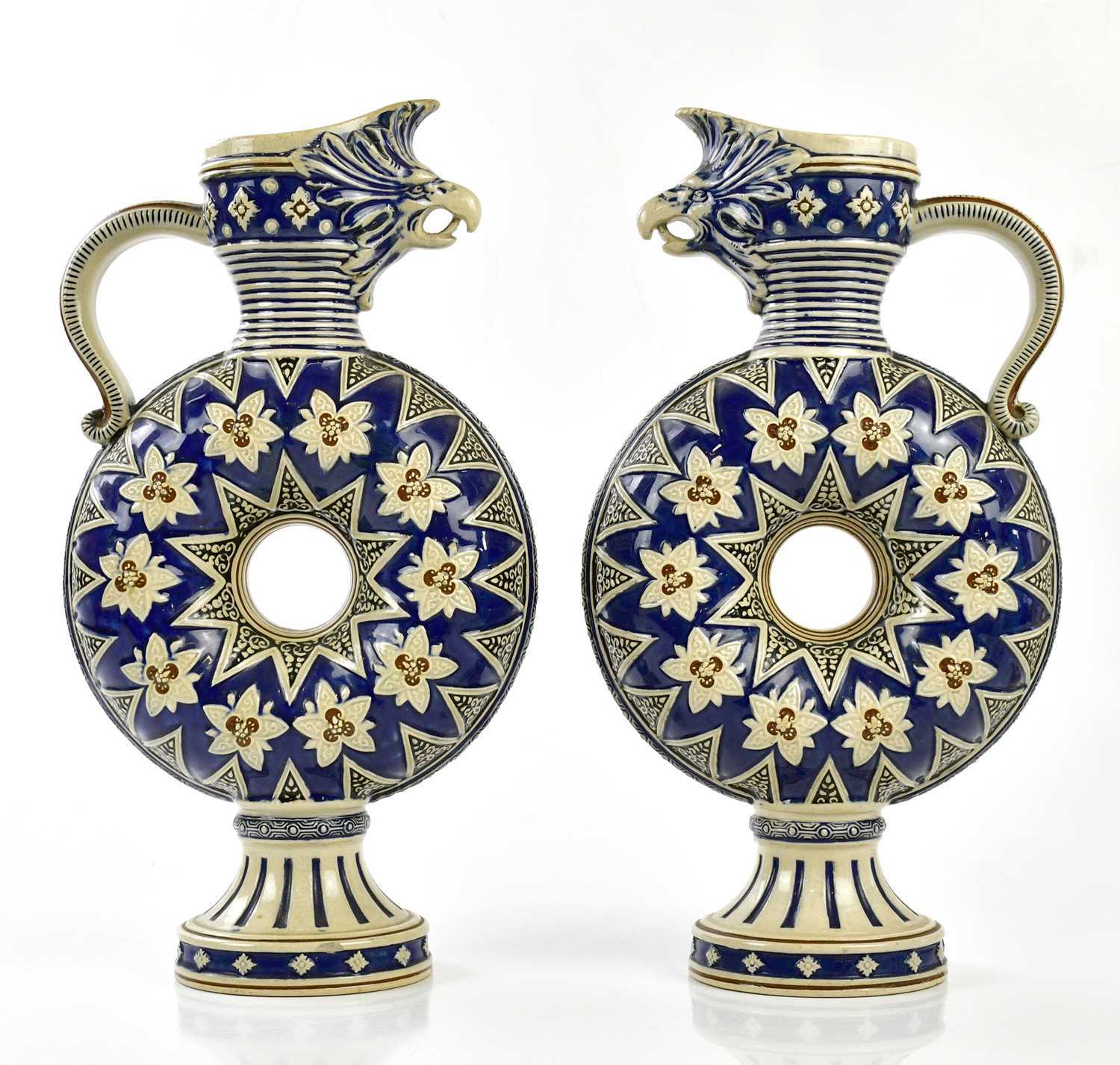 MERKELBACH & WICK; a pair of stoneware ewers, relief moulded with mythical creatures to the spout