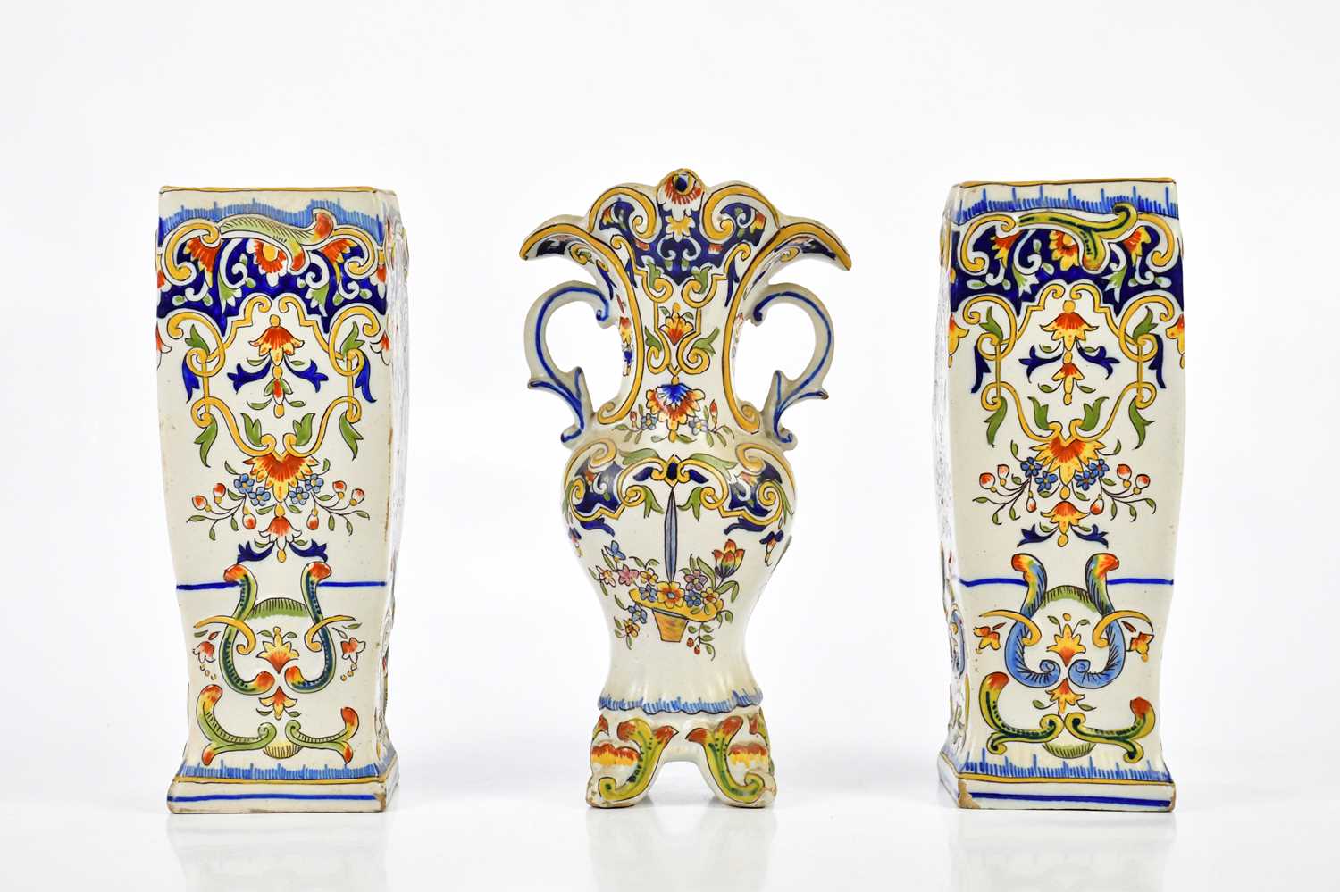 ROUEN; a pair of French faiance ware vases with moulded and painted floral detail, height 21cm,