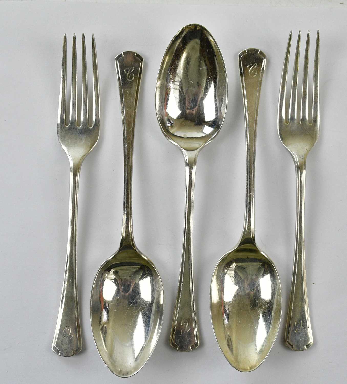 WA; a set of three George V hallmarked silver spoons, together with two forks, Sheffield 1934,