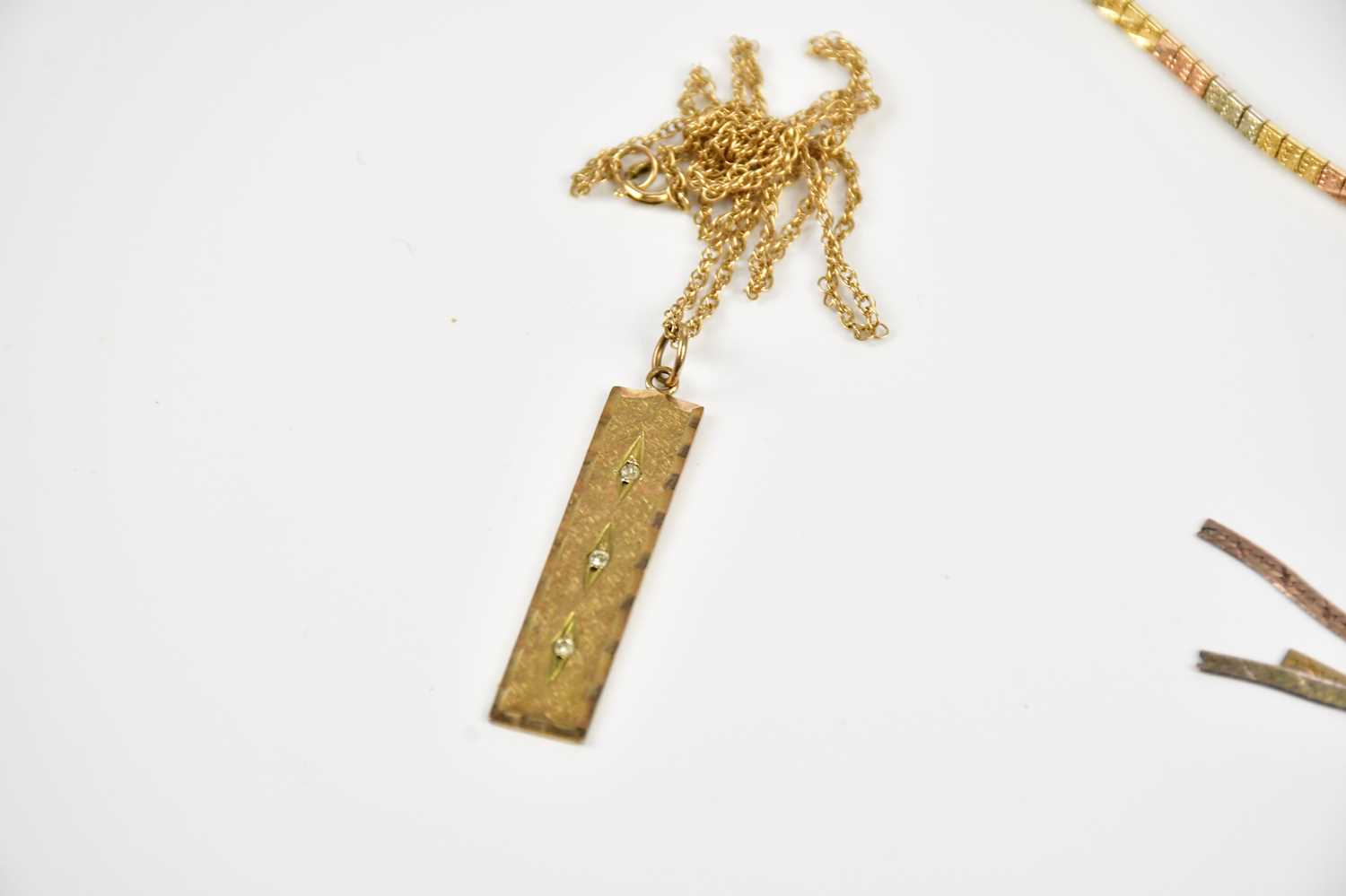 A 9ct mixed gold necklace, the 9ct ingot pendant suspended on a 9ct gold chain, and a 9ct gold - Image 4 of 6