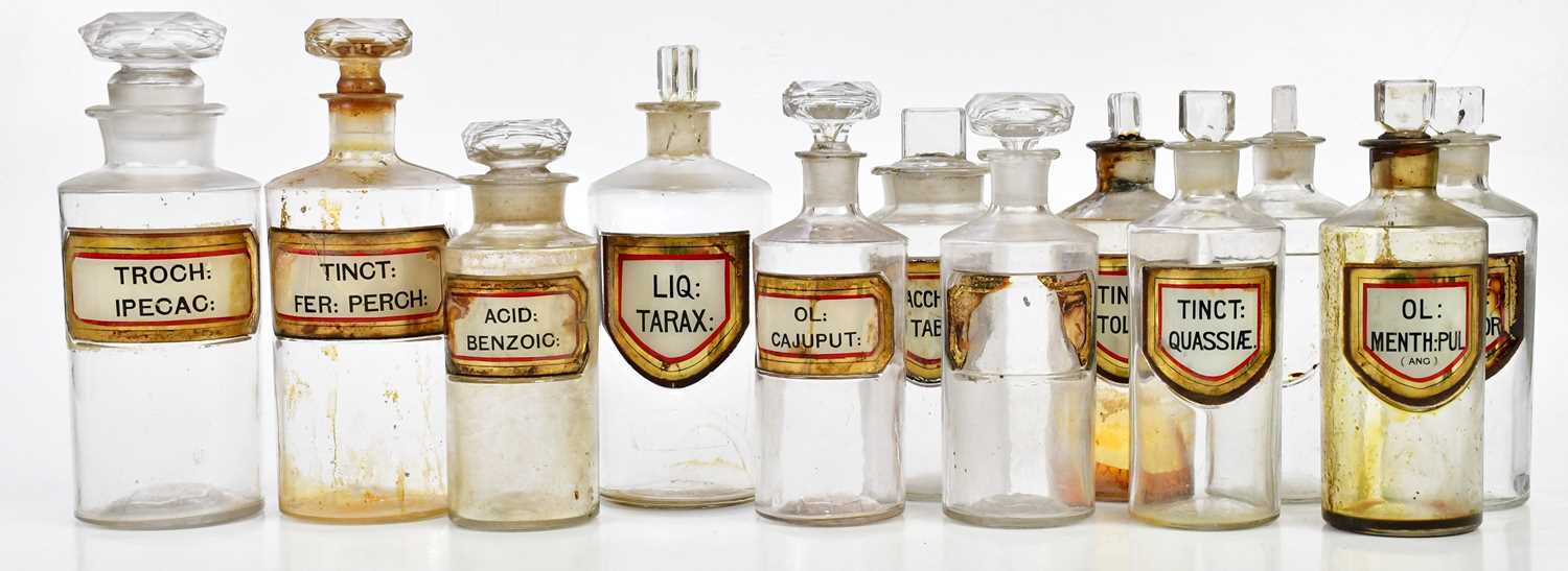 Twelve 19th century pharmacy bottles with glass labels, various names including 'Liq Tarx', 'Sacchar
