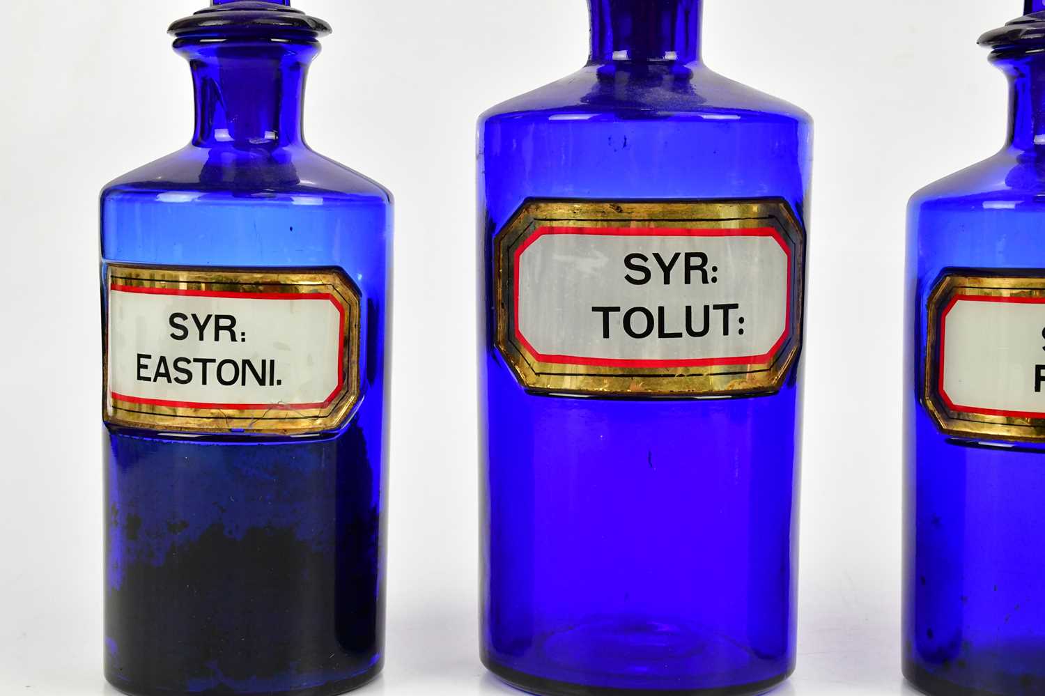 Four 19th century blue glass pharmacy bottles with labels and dummy stoppers, height of largest - Image 2 of 3