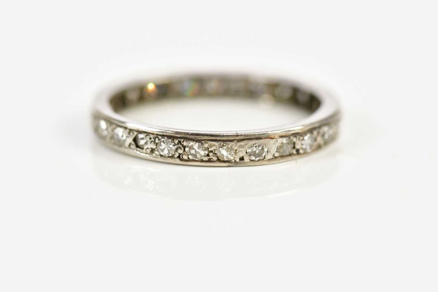 A white metal diamond set eternity ring, size O, approx 3g. - Image 2 of 3