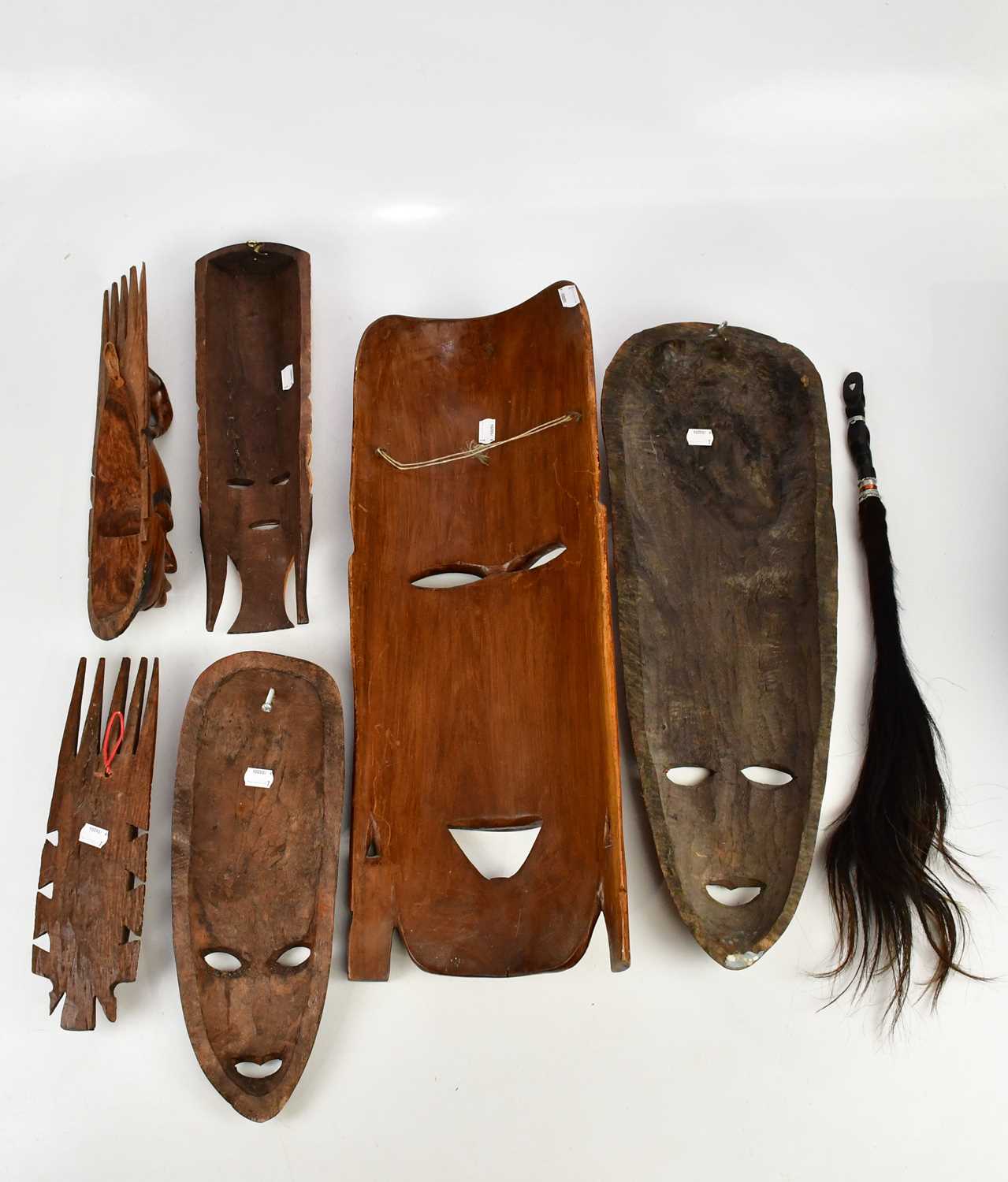 A collection of six decorative African masks, largest 63cm, together with animal hair fly swatter. - Image 5 of 5