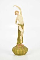 ROYAL DUX, an Art Nouveau figure of a nude dancer, on lotus flower base, height 27cm.